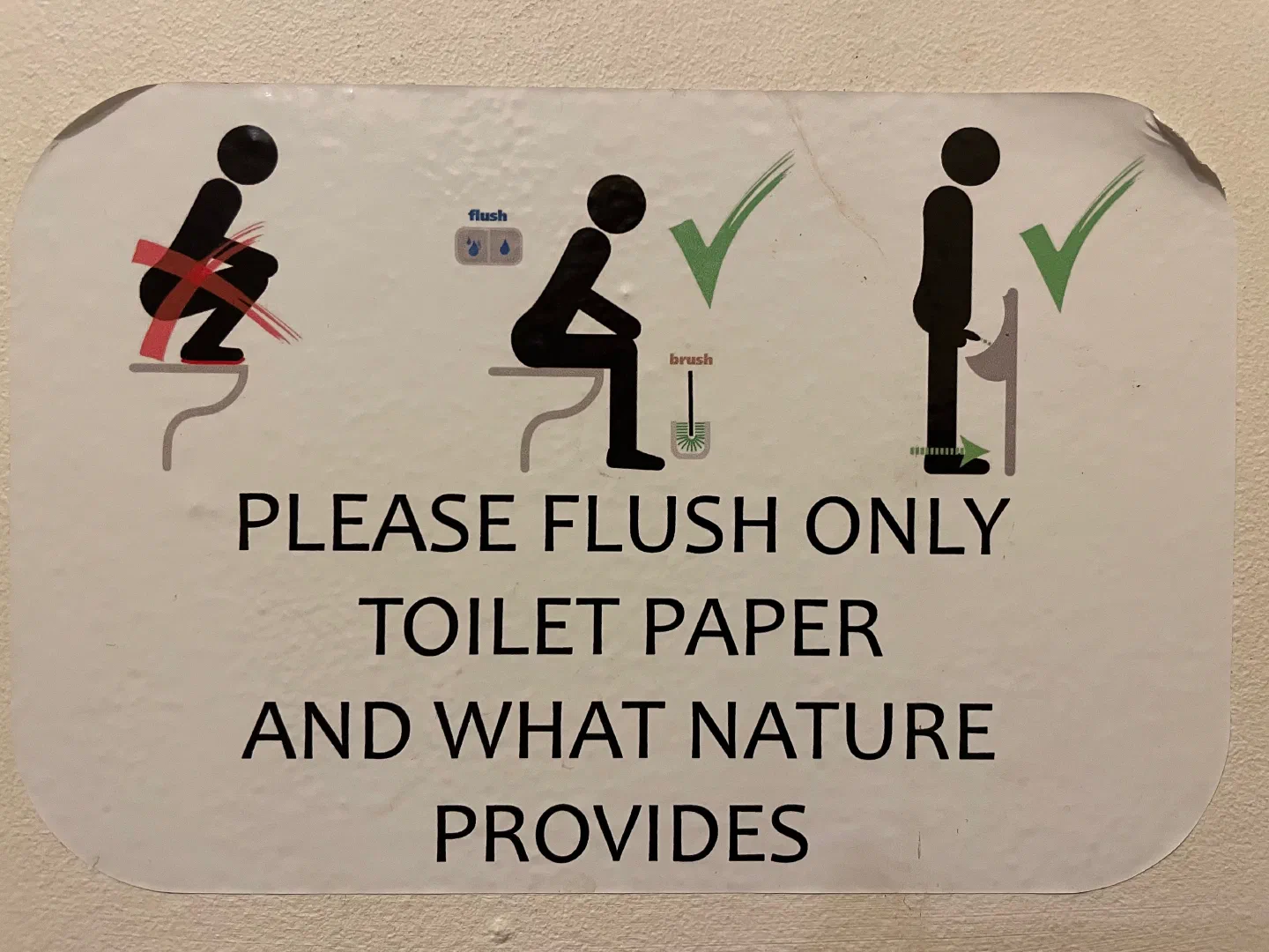 A washroom sign reading “please flush only toilet paper and what nature provides”
