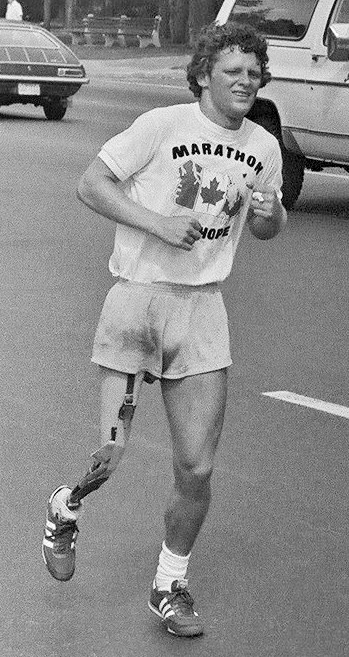 Terry Fox running down a Toronto street during his Marathon of Hope, July 1980